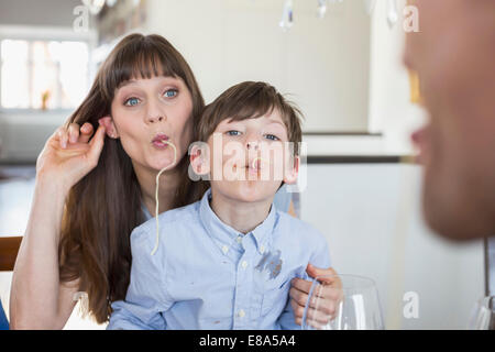 Mother and son having fun with spaghetty Stock Photo