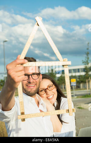 Happy couple with model house Stock Photo