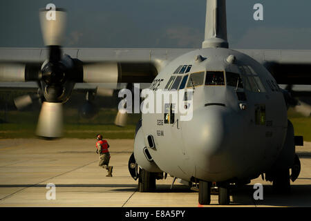 A U.S. Air Force C-130H Hercules aircraft assigned to the 142nd Airlift Squadron, Delaware Air National Guard is on the flight line at Lielvarde Air Base, Latvia, as U.S. Soldiers assigned to the 173rd Airborne Brigade Combat Team prepare to depart from t Stock Photo