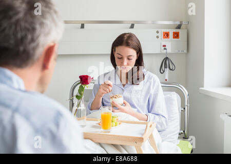 husband calling on sick wife in hosptal Stock Photo