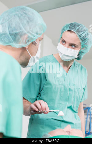 Surgeons performing operation Stock Photo