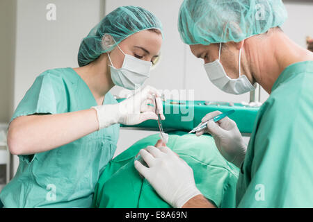 Surgeons performing operation Stock Photo