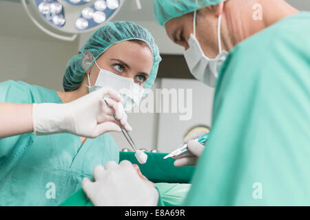 Surgeons performing operation Stock Photo