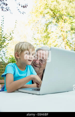 Grandmother and her grandson with laptop Stock Photo