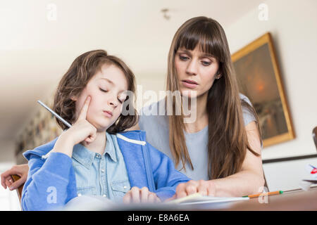 Mother helping daughter in homework Stock Photo
