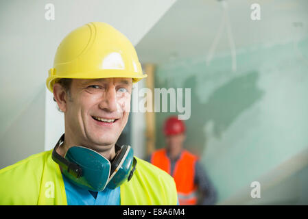 Two construction workers at construction site of new building Stock Photo