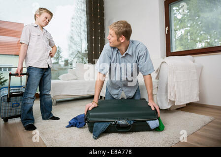 Father and son packing suitcase Stock Photo