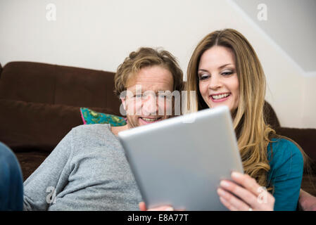 Mature couple using digital tablet at home Stock Photo