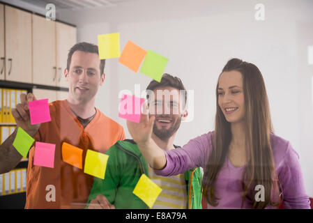 Young colleagues thinking planning using post-its Stock Photo