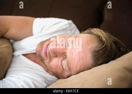Man sleeping on couch Stock Photo