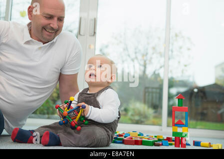 Father and his little son with building bricks Stock Photo