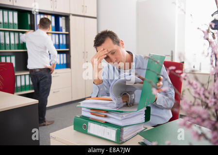 Two young men worried deadline tax stress Stock Photo