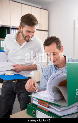 Two men office controlling checking documents Stock Photo