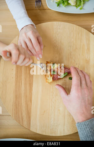 Family fighting for last slice of pizza Stock Photo