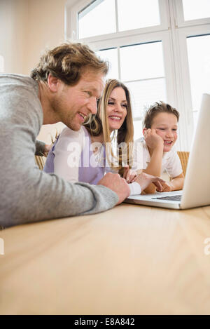 Family using laptop at home Stock Photo