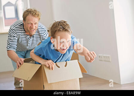Father son new apartment playing cardboard box Stock Photo