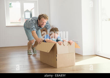 Father son new apartment playing cardboard box Stock Photo