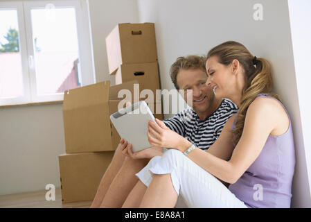 Couple sitting room planning tablet computer Stock Photo