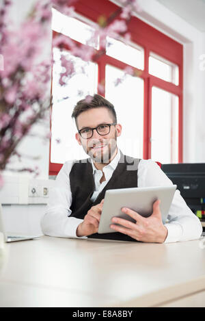office worker desk iPad working smiling Stock Photo