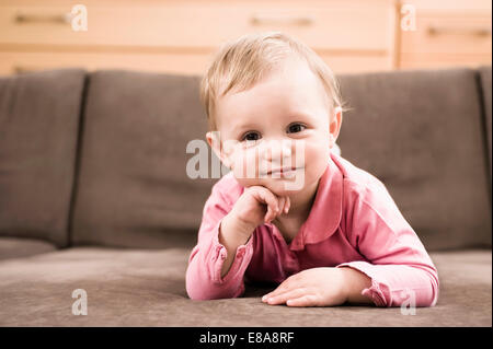 Portrait baby girl 18 months old lying on sofa Stock Photo