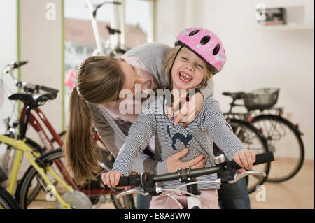 Woman and girl with mountain bike, smiling Stock Photo
