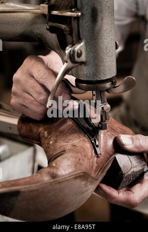 Cobbler working in workshop, close-up Stock Photo