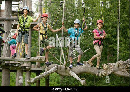 Childrens climbing on crag Stock Photo