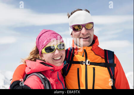 Portrait couple in winter ski suit goggle smiling Stock Photo