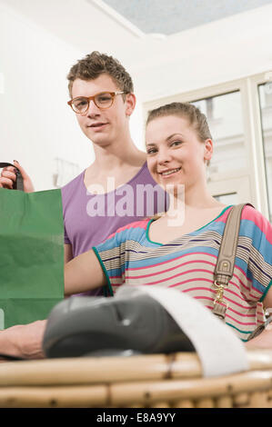 Portrait of customers at cashpoint Stock Photo