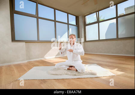 Senior man floor sitting practicing Yoga Dyana Stock Photo