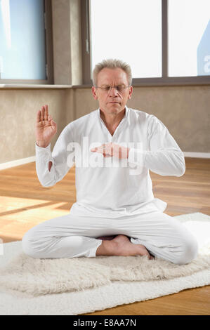 Senior man floor sitting practicing Yoga Stock Photo