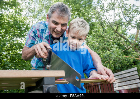 Working together handyman father son wood Stock Photo