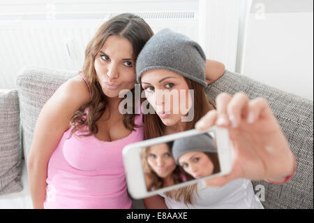 Two young women photographing herselves Stock Photo