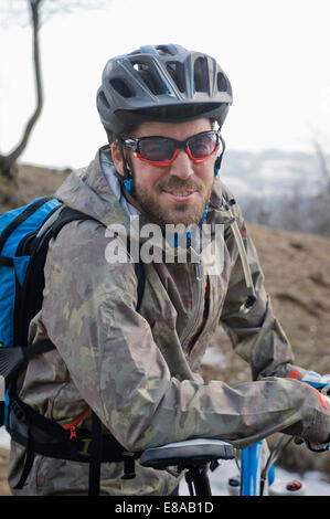 Mid adult man with mountain bike, smiling, Italy Stock Photo