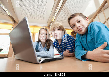 Three children with laptop Stock Photo