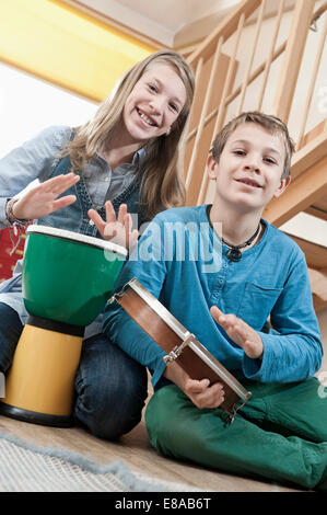 Portrait of two drumming children Stock Photo