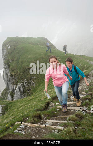Family hiking in mountains steps path Stock Photo