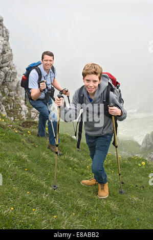 Father and son hiking in mountains Alps Stock Photo