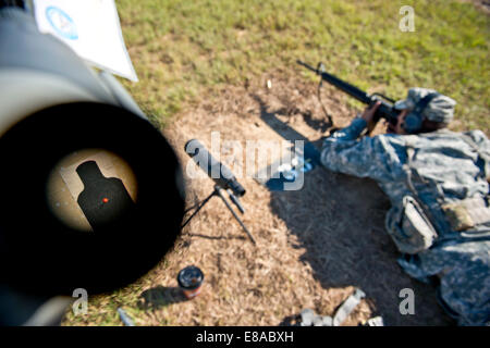 A scope shows a silhouette target 100-meters away while a U.S. Soldier zeroes his M16A2 rifle during the inaugural Army Reserve Stock Photo