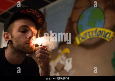 A young man smoking marihuana Inside ADICB Cannabis association.  BARCELONA COFFEE SHOPS CANNABIS Marijuana In Barcelona  If you Stock Photo