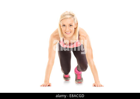 Female sprinter in starting position isolated on white background Stock Photo