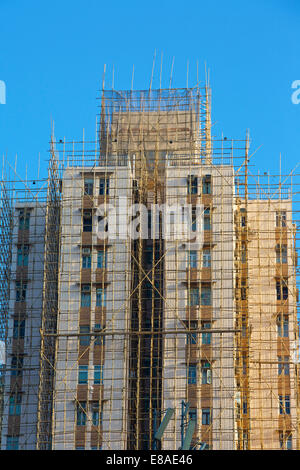 Bamboo Scaffolding Clads A Hong Kong High Rise. North Point, Hong Kong. Stock Photo