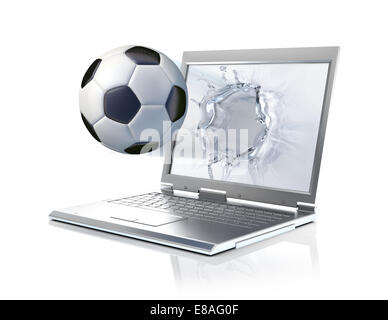 Football ball coming out from a laptop computer, forming a liquid splash on the screen. Isolated on white background Stock Photo