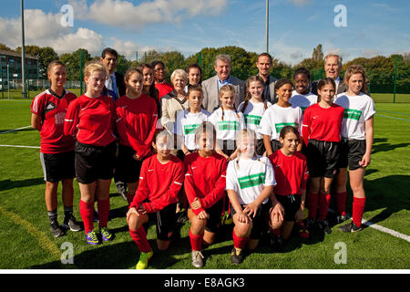 Children pose for photos with Roy Hodgson England Manager and Mark Sampson England Women's team manager, at the opening of the new 3G pitch at Charles Darwin School in Biggin Hill Stock Photo