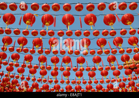 Groups of red lanterns hanging in rows above to celebrate Chinese new year Stock Photo