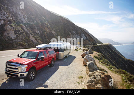 Pick-up truck with trailer attached on mountain road, Big Sur, California, USA Stock Photo