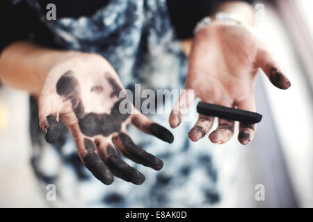 Woman's charcoal-stained hands Stock Photo