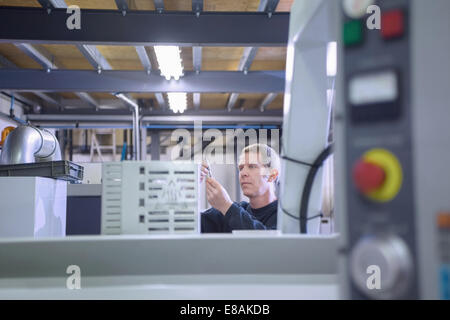 Engineer working in CNC precision engineering Stock Photo