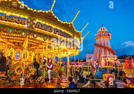 merry go round and helter skelter at night at the Nottingham Goose fair Nottingham East midlands Nottinghamshire gb uk eu europe Stock Photo