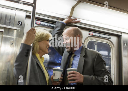 Mature couple on subway train Stock Photo